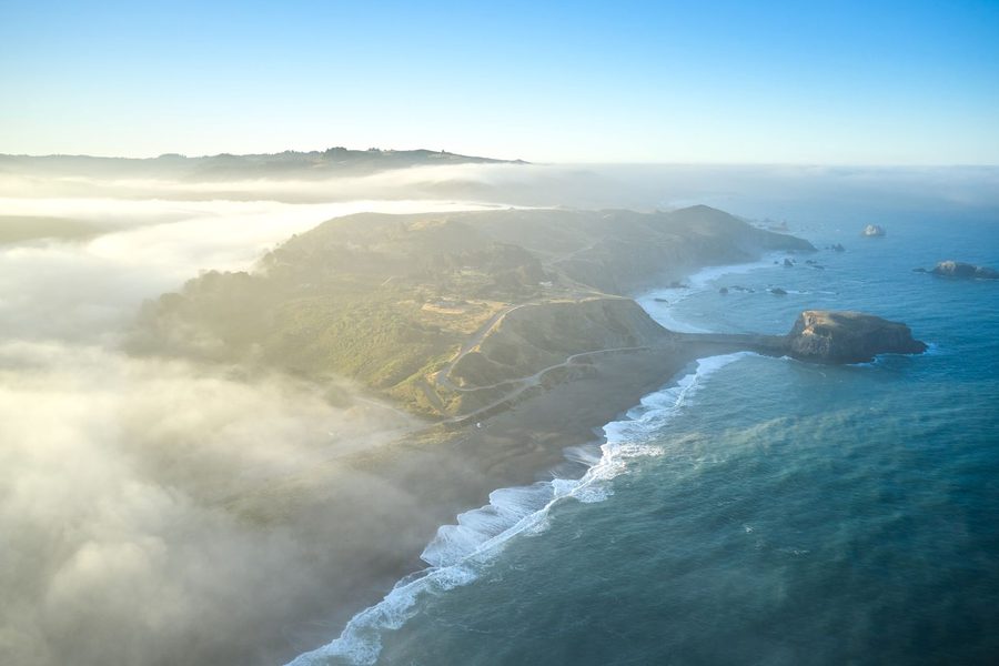 Aerial view of the fog-laced Sonoma coastline at Jenner, where the Russian River meets the Pacific.